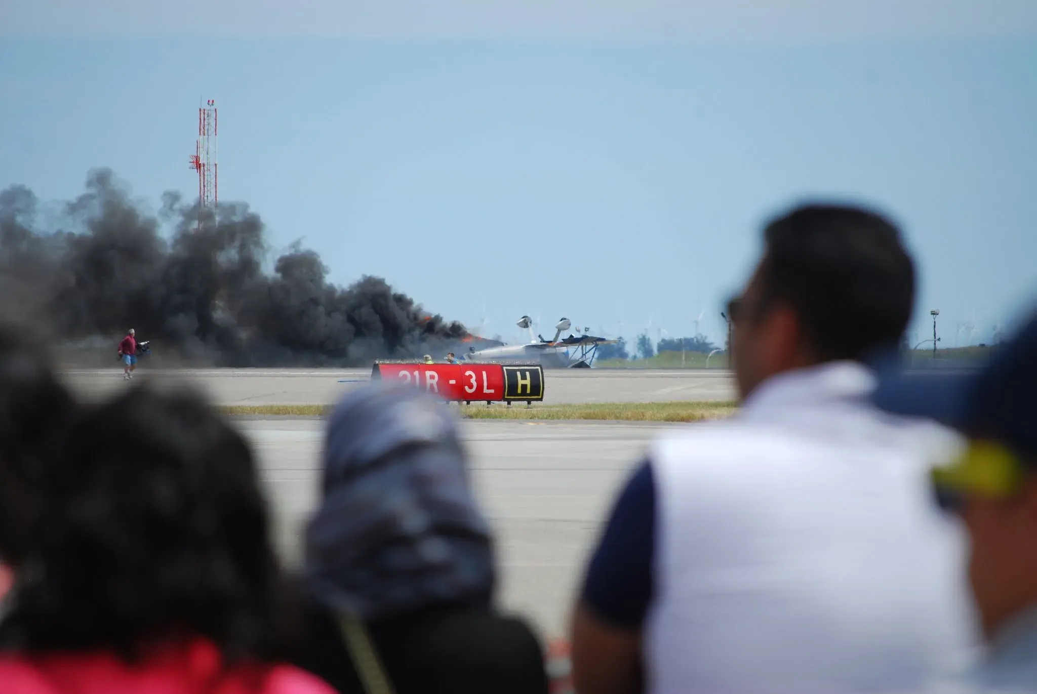 The Stearman burning on runway 21R
